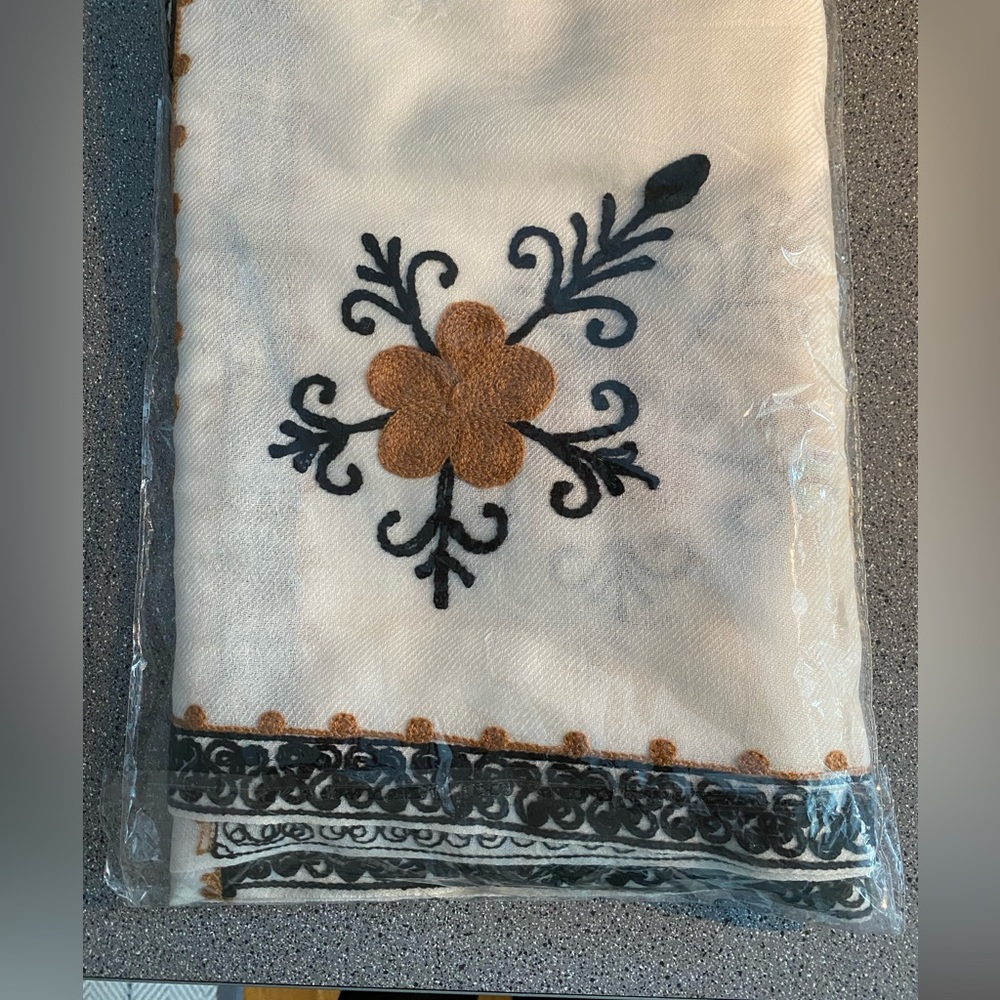 Afghan wool shawl cream-white fabric, hand stitched gold and black embroidery.